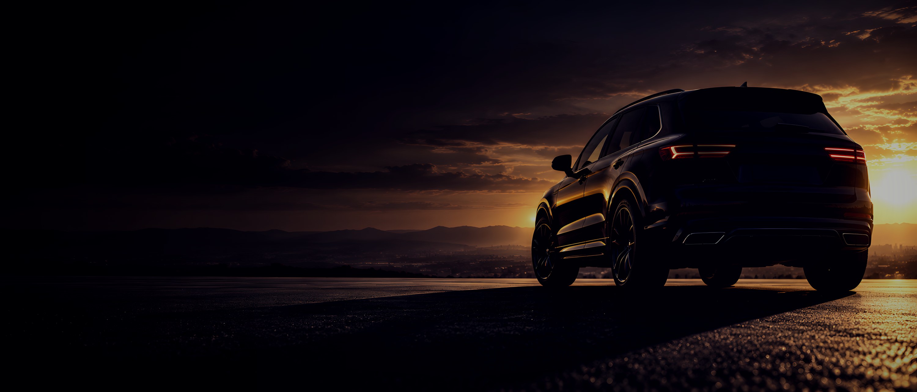 Black SUV on open asphalt at golden hour