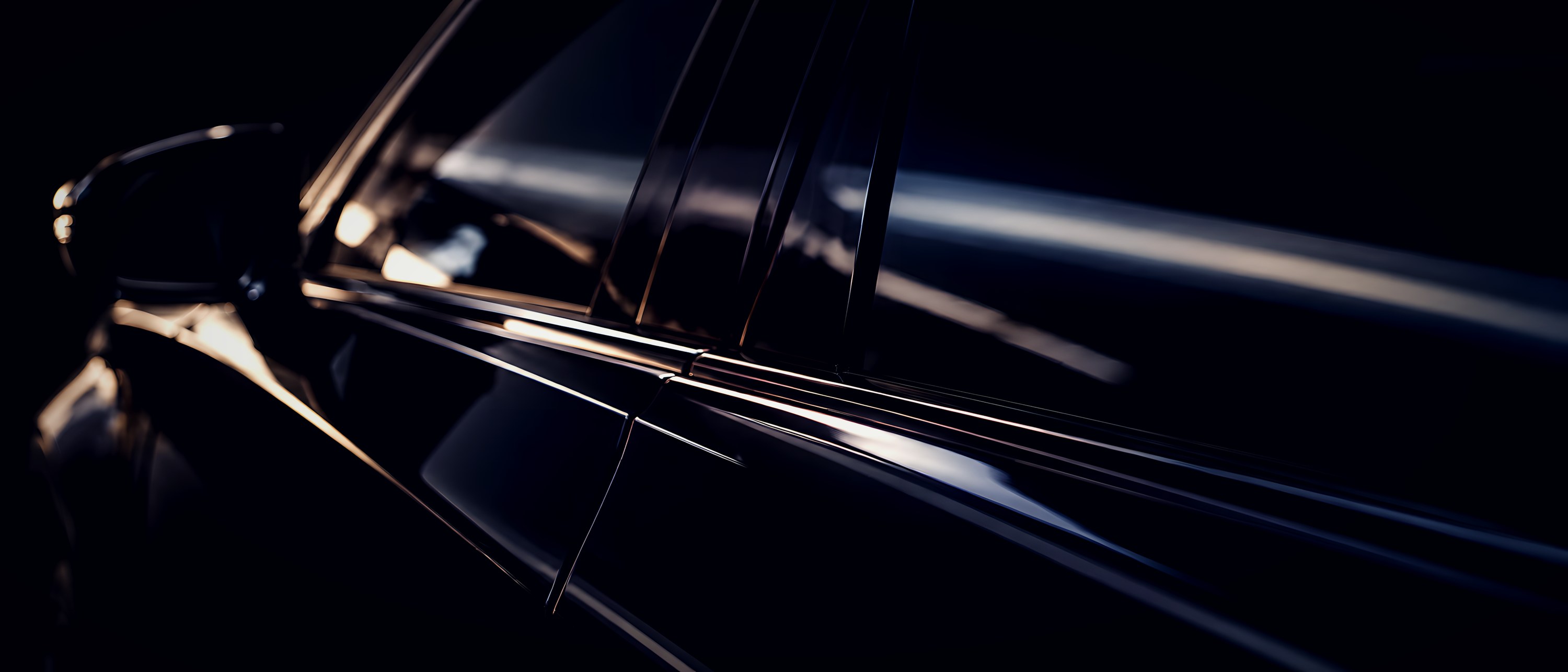 Shoulder line and tinted side window of a black car